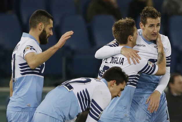 Lazio's Miroslav Klose, right, celebrates  with teammates after scoring during a Serie A soccer match between Lazio and AC Milan in Rome's Olympic stadium, Saturday, Jan. 24, 2015. (AP Photo/Gregorio Borgia)