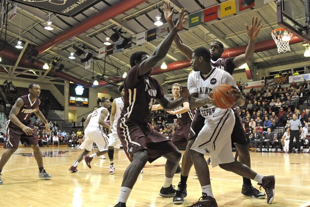 Jan 14, 2015; Philadelphia, PA, USA; Saint Joseph's Hawks guard Aaron Brown (2) is trapped by Fordham Rams guard Eric Paschall (4) and forward Ryan Rhoomes (30) during the second half at Hagan Arena. The Hawks defeated the Rams, 66-55. Mandatory Credit: Eric Hartline-USA TODAY Sports