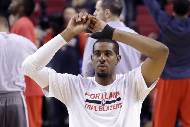 Portland Trail Blazers forward LaMarcus Aldridge sports a brace on his left hand as he stretches before the team's NBA basketball game against the Washington Wizards in Portland, Ore., Saturday, Jan. 24, 2015. Aldridge had said on Thursday that he needed surgery to repair a ligament in his left thumb and was expected to miss from six to eight weeks. But just hours before the game against the Wizards, the Blazers announced on Twitter that the three-time All-Star would play. (AP Photo/Don Ryan)