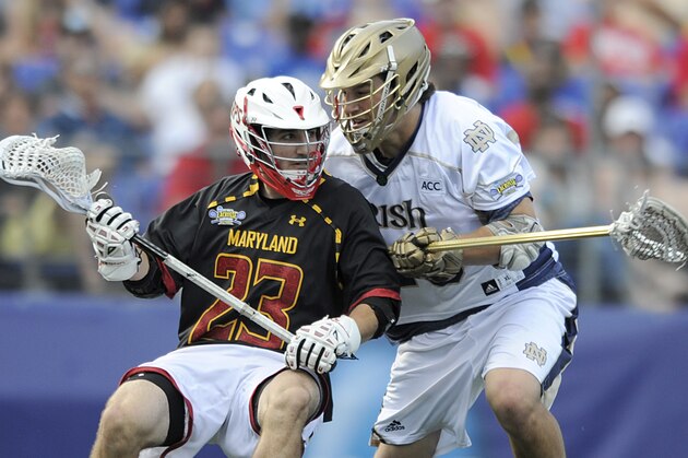Maryland's Connor Cannizzaro looks towards the goal as Notre Dame's Garrett Epple defends during the second half of an NCAA men's lacrosse semifinal, Saturday, May 24, 2014, in Baltimore. Notre Dame won 11-6. (AP Photo/Gail Burton)