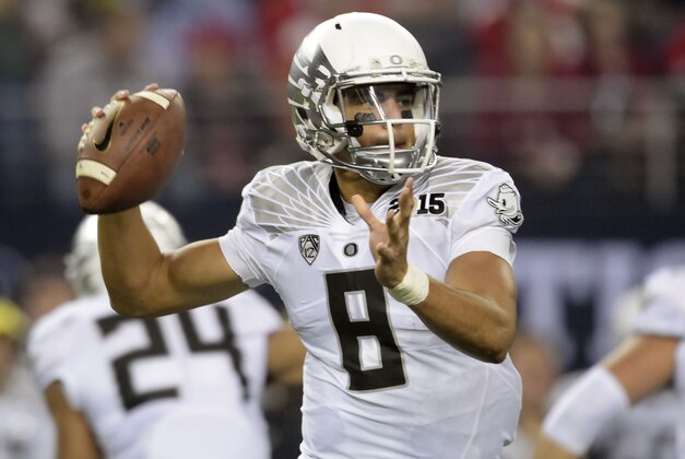 Jan 12, 2015; Arlington, TX, USA; Oregon Ducks quarterback Marcus Mariota (8) looks to pass during the first quarter against the Ohio State Buckeyes in the 2015 CFP National Championship Game at AT&T Stadium. Mandatory Credit: Kirby Lee-USA TODAY Sports