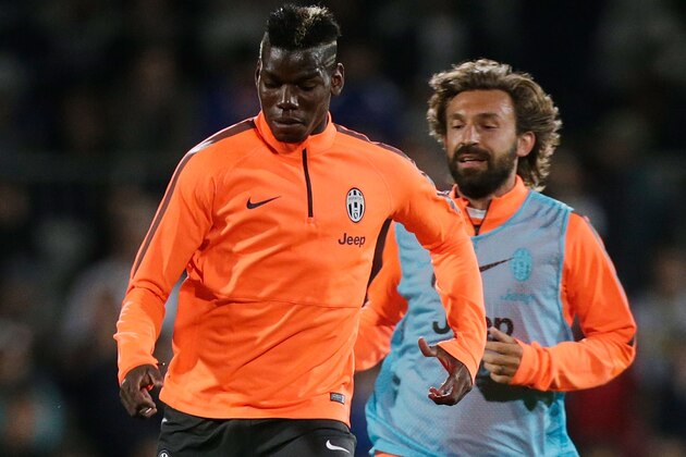 SYDNEY, AUSTRALIA - AUGUST 09:  Paul Pogba is tracked by Andrea Pirlo during a Juventus training session at WIN Jubilee Stadium on August 9, 2014 in Sydney, Australia.  (Photo by Mark Metcalfe/Getty Images)