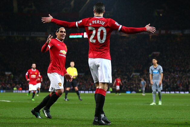 MANCHESTER, ENGLAND - DECEMBER 26:  Robin van Persie of Manchester United celebrates scoring the third goal with team-mate Radamel Falcao during the Barclays Premier League match between Manchester United and Newcastle United at Old Trafford on December 26, 2014 in Manchester, England.  (Photo by Clive Brunskill/Getty Images)