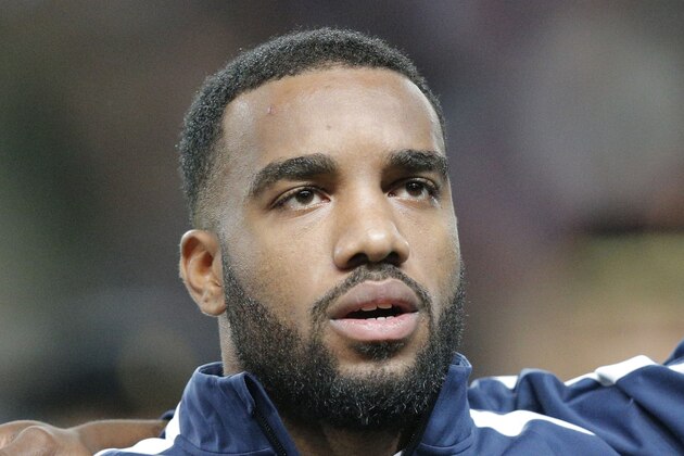 France's Alexandre Lacazette, stands at attention during the French National anthem prior to the start of a friendly soccer match France against Albania at Route de Lorient stadium in Rennes, western France, Friday, Nov. 14, 2014. The match ended in a 1-1 draw. (AP Photo/Michel Euler) France's Alexandre Lacazette, stands at attention during the French National anthem prior to the start of a friendly soccer match France against Albania at Route de Lorient stadium in Rennes, western France, Friday, Nov. 14, 2014. The match ended in a 1-1 draw. (AP Photo/Michel Euler)