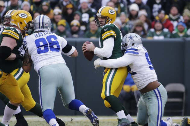 Green Bay Packers quarterback Aaron Rodgers (12) is sacked by Dallas Cowboys defensive end Jeremy Mincey (92) during the first half of an NFL divisional playoff football game Sunday, Jan. 11, 2015, in Green Bay, Wis. (AP Photo/Nam Y. Huh)