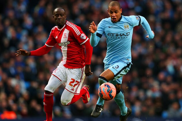 MANCHESTER, ENGLAND - JANUARY 24:  Albert Adomah of Middlesbrough chases Fernando of Manchester City as he underhits a backpass to Wilfredo Caballero of Manchester City leading to the opening goal scored by Patrick Bamford of Middlesbrough during the FA Cup Fourth Round match between Manchester City and Middlesbrough at Etihad Stadium on January 24, 2015 in Manchester, England.  (Photo by Alex Livesey/Getty Images)