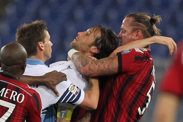 ROME, ITALY - JANUARY 24:  Philippe Mexes #5 of AC Milan and Stefano Mauri of SS Lazio react during the Serie A match between SS Lazio and AC Milan at Stadio Olimpico on January 24, 2015 in Rome, Italy.  (Photo by Paolo Bruno/Getty Images)