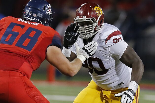 Southern California defensive tackle Claude Pelon (90) during the second half of an NCAA college football game against Arizona, Saturday, Oct. 11, 2014, in Tucson, Ariz. (AP Photo/Rick Scuteri)