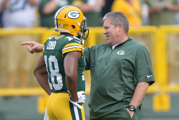Aug 22, 2014; Green Bay, WI, USA; Green Bay Packers special teams coordinator Shawn Slocum (right) tlks with receiver Randall Cobb (18) before the game against the Oakland Raiders at Lambeau Field. Mandatory Credit: Kirby Lee-USA TODAY Sports