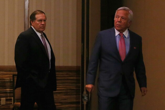 CHANDLER, AZ - JANUARY 26:  New England Patriots owner Robert Kraft walks onstage as head coach Bill Belichick looks on during the New England Patriots Media Availabiltiy on January 26, 2015 in Chandler, Arizona.  (Photo by Elsa/Getty Images)