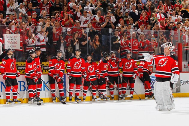 NEWARK, NJ - APRIL 13: The New Jersey Devils team tap their sticks to honor goalie Martin Brodeur #30 as Brodeur (R) salutes the fans after the Devils defeated the Boston Bruins in the final game of the 2013-2014 NHL season at the Prudential Center on April 13, 2014 in Newark, New Jersey. The Devils defeated the Bruins 3-2. (Photo by Andy Marlin/NHLI via Getty Images)