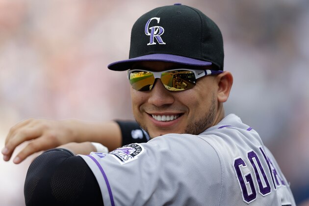 ATLANTA, GA - MAY 24:  Outfielder Carlos Gonzalez #5 of the Colorado Rockies laughs in the dugout during the game against the Atlanta Braves  at Turner Field on May 24, 2014 in Atlanta, Georgia.  (Photo by Mike Zarrilli/Getty Images)
