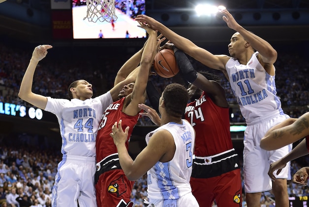 Jan 10, 2015; Chapel Hill, NC, USA; North Carolina Tar Heels forwards Justin Jackson (44) and Kennedy Meeks (3) and Brice Johnson (11) fight for the ball with Louisville Cardinals forwards Wayne Blackshear (25) and Montrezl Harrell (24) in the first half at Dean E. Smith Center. Mandatory Credit: Bob Donnan-USA TODAY Sports