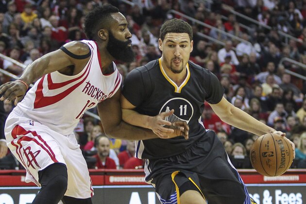 Jan 17, 2015; Houston, TX, USA; Golden State Warriors guard Klay Thompson (11) drives to the basket during the third quarter as Houston Rockets guard James Harden (13) defends at Toyota Center. Mandatory Credit: Troy Taormina-USA TODAY Sports