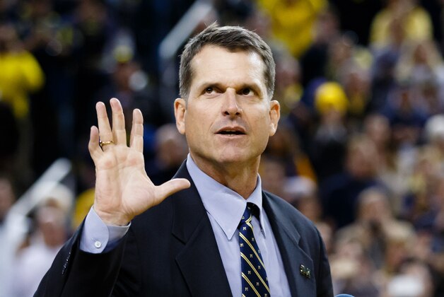 Dec 30, 2014; Ann Arbor, MI, USA; Michigan Wolverines head football coach Jim Harbaugh address the crowd during halftime of the basketball game against the Illinois Fighting Illini at Crisler Center. Mandatory Credit: Rick Osentoski-USA TODAY Sports