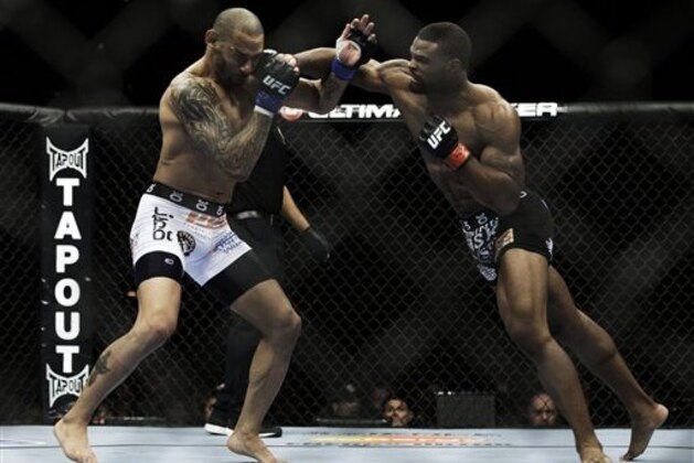 Tyron Woodley connects with a right to Jay Hieron during their UFC 156 welterweight mixed martial arts match, Saturday, Feb. 2, 2013 at The Mandalay Bay Resort & Casino in Las Vegas. Woodley won the match. (AP Photo/Eric Jamison)