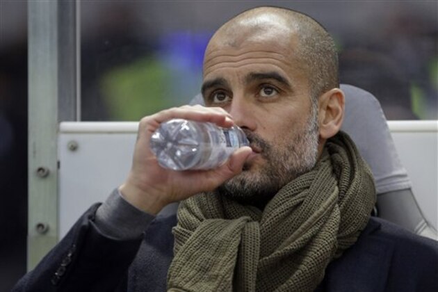 Bayern's head coach Pep Guardiola drinks as he arrives for the German Bundesliga soccer match between Hertha BSC and FC Bayern Munich at the Olympia stadium in Berlin, Germany, Saturday, Nov. 29, 2014. Munich defeated Berlin by1-0. (AP Photo/Michael Sohn)