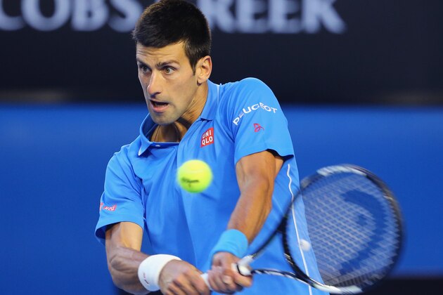 MELBOURNE, AUSTRALIA - JANUARY 28:  Novak Djokovic of Serbia plays a backhand in his quarter final match against Milos Raonic of Canada during day 10 of the 2015 Australian Open at Melbourne Park on January 28, 2015 in Melbourne, Australia.  (Photo by Scott Barbour/Getty Images)