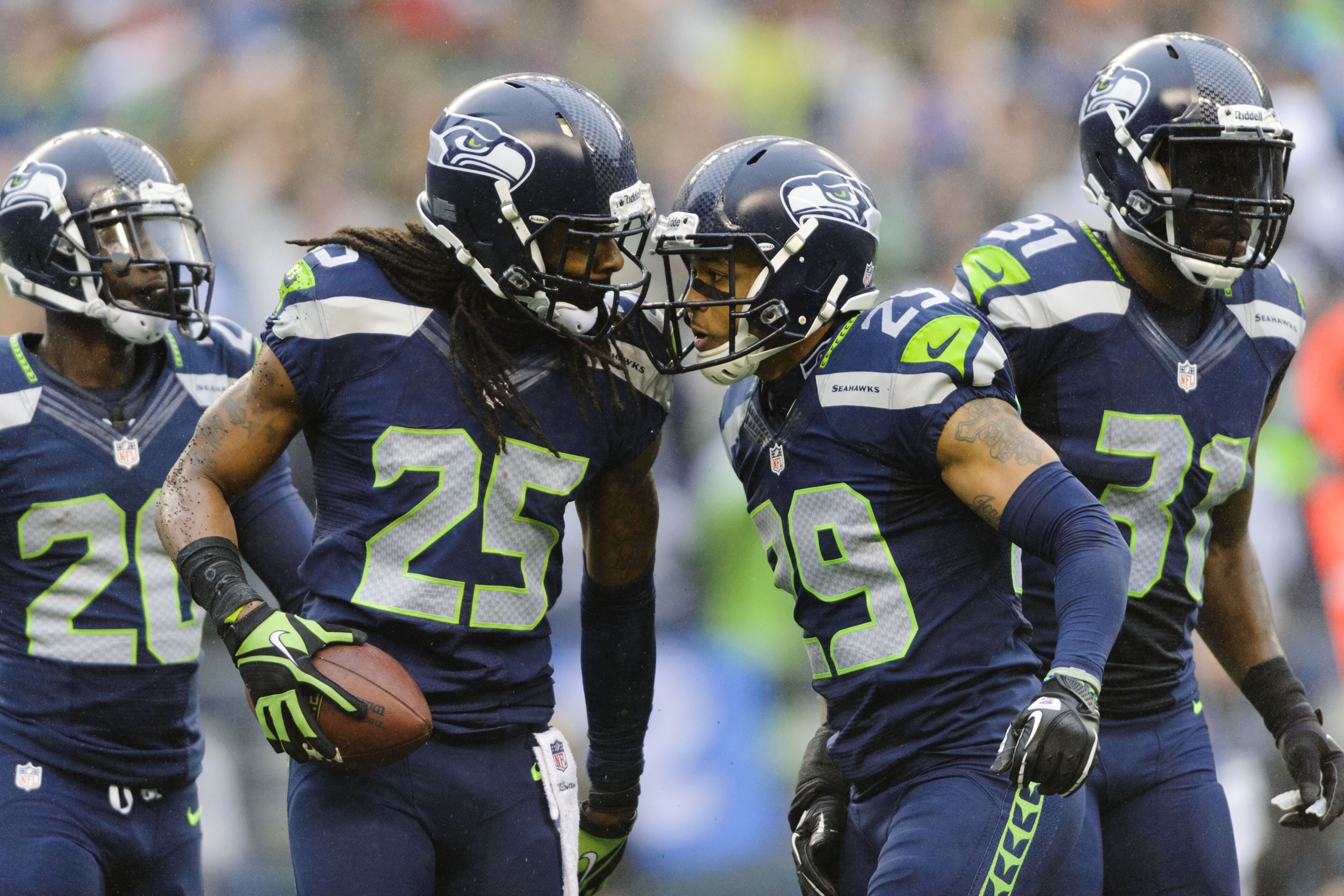 Dec 22, 2013; Seattle, WA, USA; Seattle Seahawks cornerback Richard Sherman (25) and free safety Earl Thomas (29) celebrate after Sherman intercepted the ball thrown by Arizona Cardinals quarterback Carson Palmer (not pictured) during the game at CenturyLink Field. Arizona defeated Seattle 17-10. Mandatory Credit: Steven Bisig-USA TODAY Sports