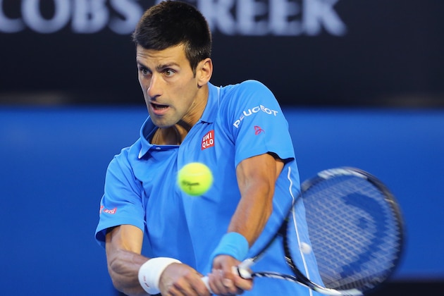 MELBOURNE, AUSTRALIA - JANUARY 28:  Novak Djokovic of Serbia plays a backhand in his quarter final match against Milos Raonic of Canada during day 10 of the 2015 Australian Open at Melbourne Park on January 28, 2015 in Melbourne, Australia.  (Photo by Scott Barbour/Getty Images)
