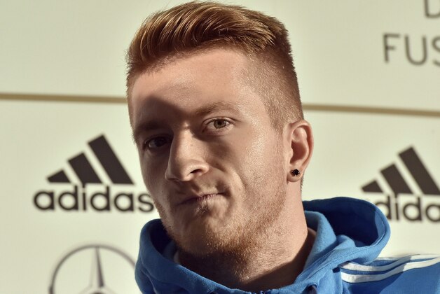 FILE - In this Sept.5, 2014 file photo German player Marco Reus watches out of the shadow during a press conference in Kamen, Germany, prior the UEFA EURO 2016 qualifying soccer match between Germany and Scotland. A German newspaper is reporting Thursday, Dec. 18, 2014, that Germany and Borussia Dortmund forward Reus has been fined 540,000 euro ($673,000) for repeatedly driving without a license. (AP Photo/Martin Meissner, File)