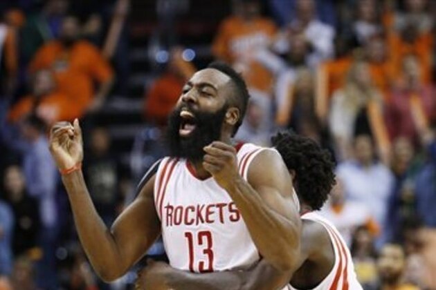 Houston Rockets' James Harden (13) celebrates with Patrick Beverley, rear, after his game-winning shot against the Phoenix Suns in an NBA basketball game Friday, Jan. 23, 2015, in Phoenix. The Rockets defeated the Suns 113-111. (AP Photo/Ross D. Franklin)