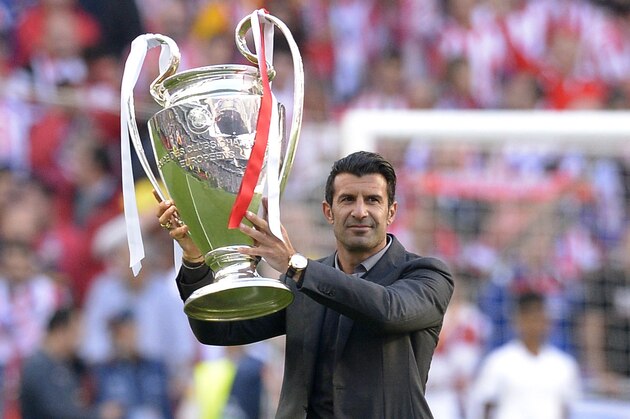 Former Real player Luis Figo holds the Champions League trophy, ahead of the Champions League final soccer match between Atletico Madrid and Real Madrid in Lisbon, Portugal, Saturday, May 24, 2014. (AP Photo/Manu Fernandez)