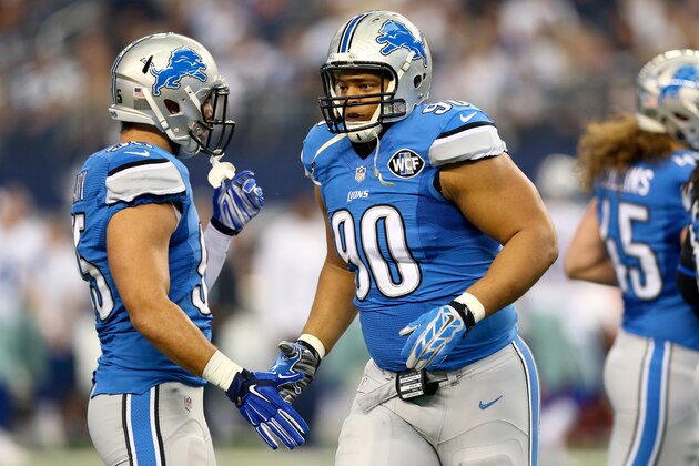 ARLINGTON, TX - JANUARY 04:  Defensive tackle Ndamukong Suh #90 of the Detroit Lions gives outside linebacker Kyle Van Noy #95 a five in the first quarter against the Dallas Cowboys during the NFC Wildcard Playoff Game at AT&T Stadium on January 4, 2015 in Arlington, Texas.  (Photo by Ronald Martinez/Getty Images)
