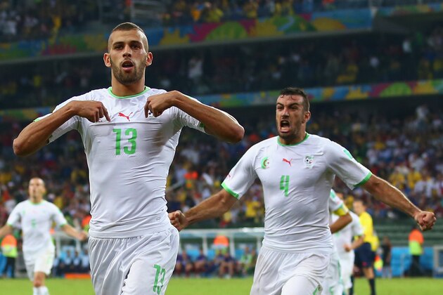 CURITIBA, BRAZIL - JUNE 26:  Islam Slimani of Algeria (L) celebrates scoring his team's first goal with Essaid Belkalem during the 2014 FIFA World Cup Brazil Group H match between Algeria and Russia at Arena da Baixada on June 26, 2014 in Curitiba, Brazil.  (Photo by Julian Finney/Getty Images)