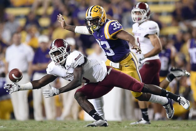 BATON ROUGE, LA - SEPTEMBER 27:  Rayvean Moore #9 of the New Mexico State Aggies reaches for a pass in front of Jamal Adams #33 of the LSU Tigers during the third quarter of a game at Tiger Stadium on September 27, 2014 in Baton Rouge, Louisiana.  LSU won the game 63-7.  (Photo by Stacy Revere/Getty Images)
