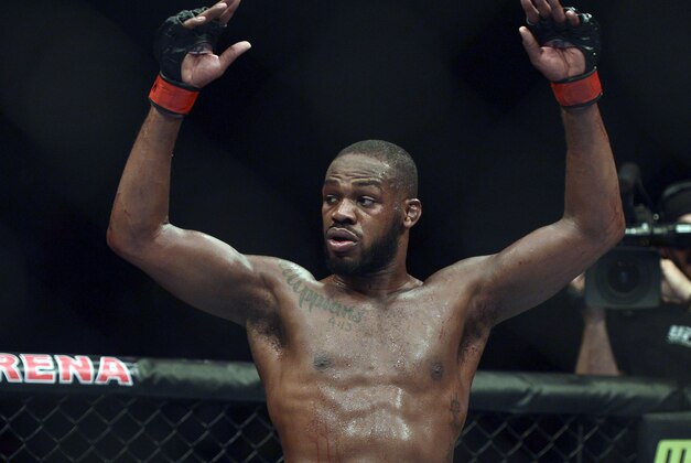 Apr 26, 2014; Baltimore, MD, USA;  Jon Jones puts his arms in the air after the UFC light heavy weight championship fight against Glover Texeira at  Baltimore Arena. Jones retained the light heavy height championship by defeating  Teixeria.  Mandatory Credit: Tommy Gilligan-USA TODAY Sports