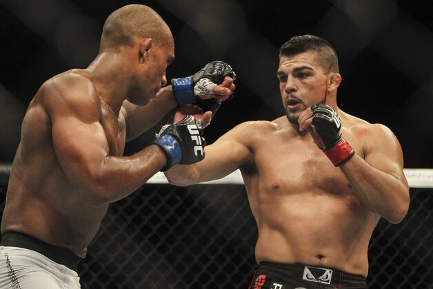 Jun 28, 2014; San Antonio, TX, USA; Kelvin Gastelum (red gloves) fights Nico Musoke (blue gloves) in a Welterweight bout at UFC Fight Night 43 at AT&T Center. Mandatory Credit: Troy Taormina-USA TODAY Sports