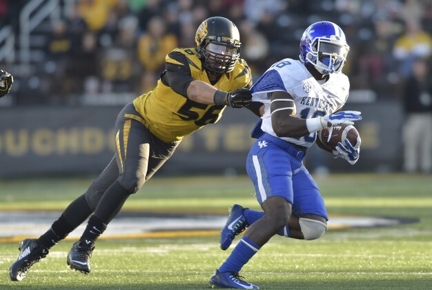 Nov 1, 2014; Columbia, MO, USA; Kentucky Wildcats running back Stanley Williams (18) is tackled by Missouri Tigers defensive lineman Shane Ray (56) during the second half at Faurot Field. Missouri won 20-10. Mandatory Credit: Denny Medley-USA TODAY Sports