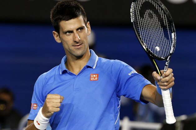 Novak Djokovic of Serbia celebrates after defeating Milos Raonic of Canada in their quarterfinal match at the Australian Open tennis championship in Melbourne, Australia, Wednesday, Jan. 28, 2015. (AP Photo/Vincent Thian)