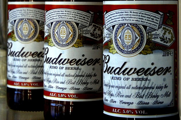 FILE - This Jan. 27, 2009 file photo shows bottles of Budweiser beer at the Stag Brewery in London. Anheuser-Busch is bringing back its canine and Clydesdales combo this Super Bowl, hoping to top last year's