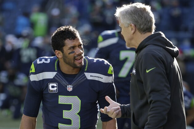 Seattle Seahawks quarterback Russell Wilson (3) talks with head coach Pete Carroll during warmups before an NFL football game against the San Francisco 49ers, Sunday, Dec. 14, 2014, in Seattle. (AP Photo/Elaine Thompson)