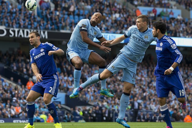 Manchester City's Edin Dzeko, second right and Vincent Kompany, centre left, jump for a ball as Chelsea's Branislav Ivanovic, left, and Diego Costa look on during their English Premier League soccer match at the Etihad Stadium, Manchester, England, Sunday Sept. 21, 2014. (AP Photo/Jon Super) Manchester City's Edin Dzeko, second right and Vincent Kompany, centre left, jump for a ball as Chelsea's Branislav Ivanovic, left, and Diego Costa look on during their English Premier League soccer match at the Etihad Stadium, Manchester, England, Sunday Sept. 21, 2014. (AP Photo/Jon Super)