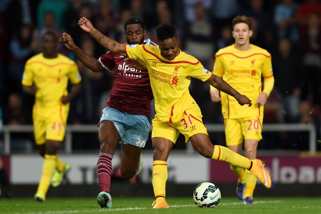 Liverpool’s Raheem Sterling, front, competes for the ball with West Ham United’s Alex Song during their English Premier League soccer match at Upton Park, London, Saturday, Sept. 20, 2014. (AP Photo/Tim Ireland)