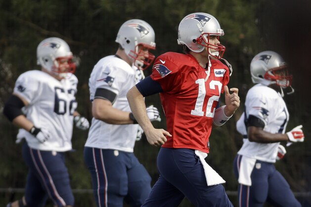 New England Patriots quarterback Tom Brady (12) warms up with teammates during practice Wednesday, Jan. 28, 2015, in Tempe, Ariz. The Patriots play the Seattle Seahawks in NFL football Super Bowl XLIX Sunday, Feb. 1, in Glendale, Ariz. (AP Photo/Mark Humphrey)