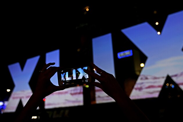 A woman takes a photo of Roman numerals for Super Bowl XLIX Wednesday, Jan. 28, 2015, in downtown Phoenix. The New England Patriots face the Seattle Seahawks in Super Bowl XLIX on Sunday in Glendale, Ariz. (AP Photo/Charlie Riedel)