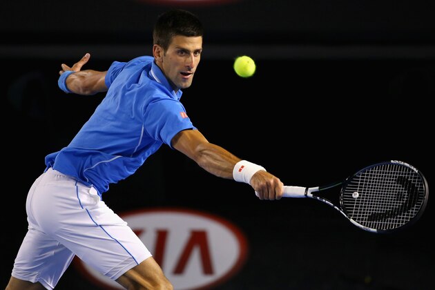 MELBOURNE, AUSTRALIA - JANUARY 28:  Novak Djokovic of Serbia plays a backhand in his quarter final match against Milos Raonic of Canada during day 10 of the 2015 Australian Open at Melbourne Park on January 28, 2015 in Melbourne, Australia.  (Photo by Quinn Rooney/Getty Images)