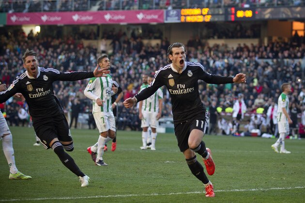 Real Madrid's Gareth Bale, right, celebrates after scoring against Cordoba during their La Liga soccer match at the Arcangel stadium, in Cordoba, Spain on Saturday, Jan. 24, 2015. (AP Photo/Miguel Morenatti)