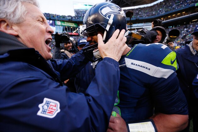 SEATTLE, WA - JANUARY 18:  Head coach Pete Carroll and  Russell Wilson #3 of the Seattle Seahawks celebrate after the Seahawks 28-22 victory in overtime against the Green Bay Packers during the 2015 NFC Championship game at CenturyLink Field on January 18, 2015 in Seattle, Washington.  (Photo by Kevin C. Cox/Getty Images)