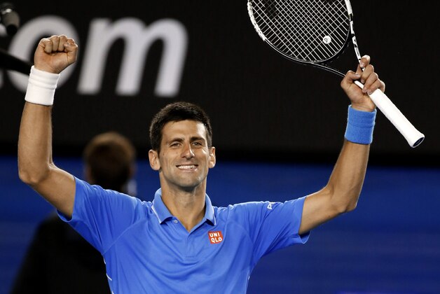 Novak Djokovic of Serbia celebrates after defeating Milos Raonic of Canada in their quarterfinal match at the Australian Open tennis championship in Melbourne, Australia, Wednesday, Jan. 28, 2015. (AP Photo/Vincent Thian)