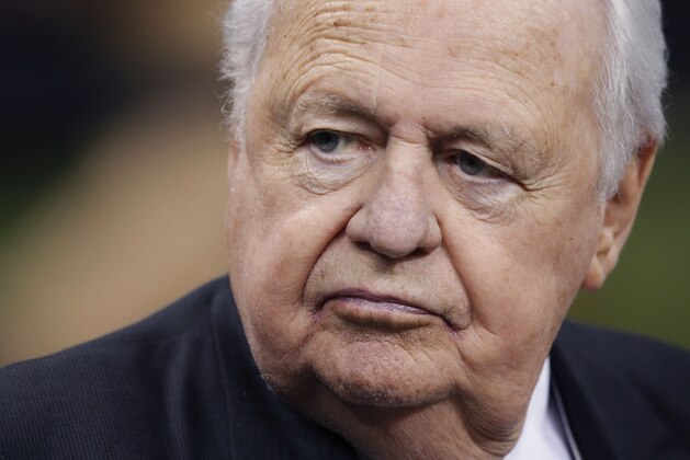 New Orleans Saints owner Tom Benson walk-on the field before an NFL football game against the Tennessee Titans in New Orleans, Friday, Aug. 15, 2014. (AP Photo/Bill Haber)