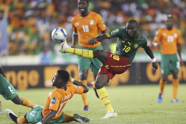 Cameroon's Aboubakar Vincent is tackled by Ivory Coast's Sergie Aurier, right, during their African Cup of Nations Group D soccer match at Estadio De Malabo in Malabo, Equatorial Guinea, Wednesday, Jan. 28, 2015. (AP Photo/Sunday Alamba)