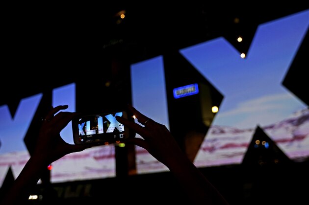 A woman takes a photo of Roman numerals for Super Bowl XLIX Wednesday, Jan. 28, 2015, in downtown Phoenix. The New England Patriots face the Seattle Seahawks in Super Bowl XLIX on Sunday in Glendale, Ariz. (AP Photo/Charlie Riedel)