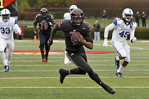 Louisville wide receiver DeVante Park finds a seam in the Kentucky defensive secondary to score on a 33-yard pass and run in the NCAA college football game against rival Kentucky on Saturday, Nov. 29, 2014, in Louisville, Ky. Parker scored three times as Louisville beat Kentucky 44-40. (AP Photo/Garry Jones)