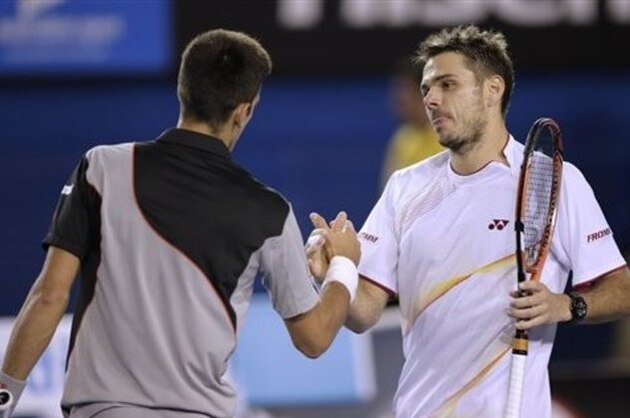 Stanislas Wawrinka of Switzerland, right, shakes hands with Novak Djokovic of Serbia at the net after Wawrinka's win in their quarterfinal at the Australian Open tennis championship in Melbourne, Australia, Tuesday, Jan. 21, 2014.(AP Photo/Rick Rycroft)