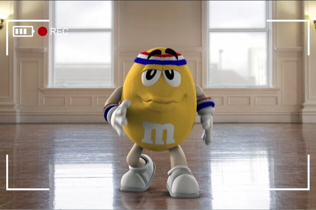 This image provided by Mars Inc. shows an online teaser ad for M&M's Super Bowl ad featuring its yellow peanut M&M “spokescandy”. The teaser is part of a Super Bowl ad trend: More content is being released ahead of time online in the hope that it goes viral. Advertisers are seeking to drum up excitement for their spots running during the big game, when more than 108 million people are expected to watching Feb. 2. (AP Photo/Mars Inc.)